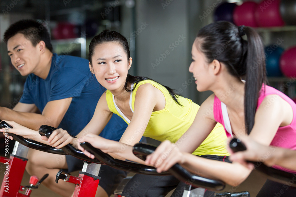 Group of young people spinning in the gym Group of young people spinning in the gym