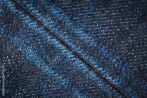 Dark blue denim jeans with seam texture background.