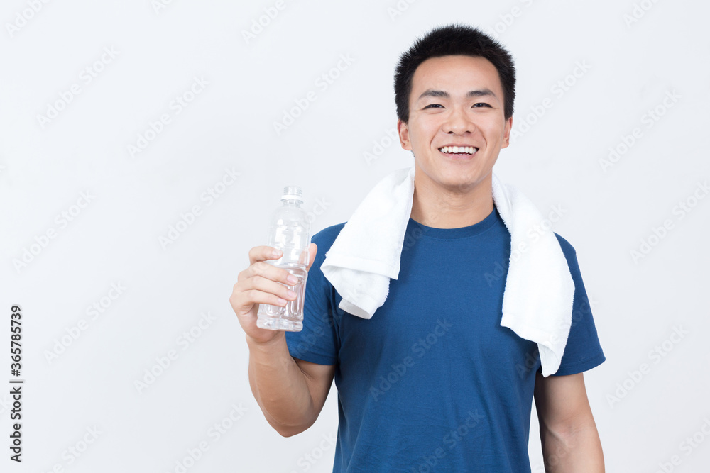 Young Asian man drinking water after sports Young Asian man drinking water after sports