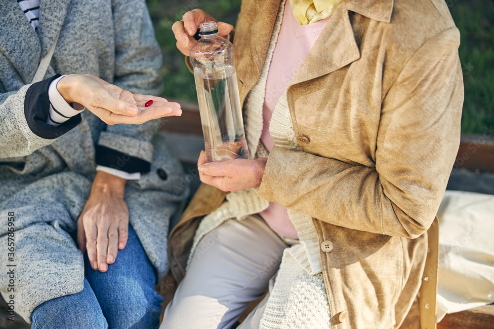 Cropped photo of lady giving pill for friend