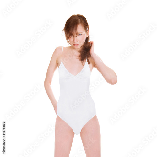 Gorgeous young woman wearing a white bathing suit, closeup portrait isolated in front of white studio background © Jochen Schönfeld