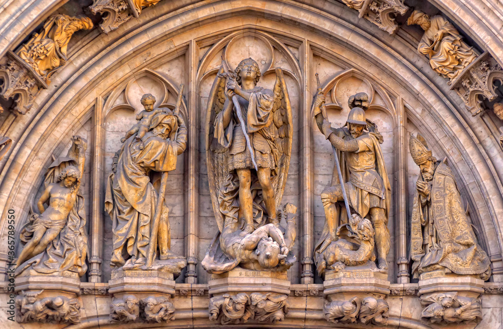 Group of sculptures with religious motives above entrance to the courtyard in Town Hall in Brussels, Belgium.