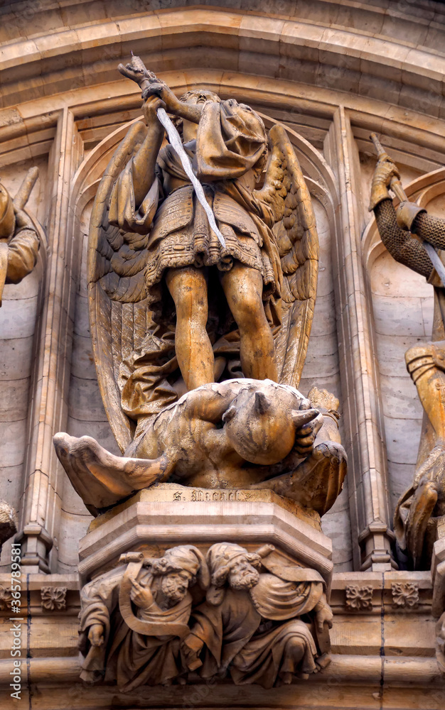 Saint Michael the Archangel killing the devil statue at facade of Town Hall in Brussels, Belgium.