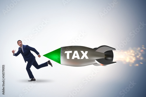 Concept of tax with businessman chased by rocket