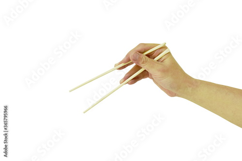 hand holding and use wooden chopsticks on white background