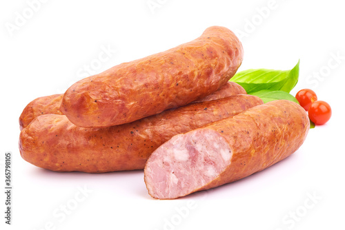 Delicious Smoked Sliced Sausages with Basil leaves, isolated on a white background. Close-up.