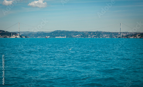 15 July Martyrs Bridge is visible while a big Cargo ship is passing under. Istanbul sea traffic in Marmara sea. Istanbul strait and copy space available.
