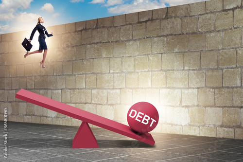 Debt and loan concept with businesswoman and seesaw photo