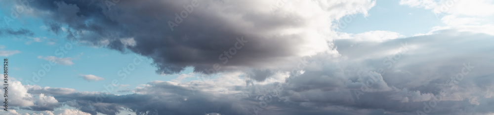 Blue sky with storm clouds. Abstract background and texture, nature. Image panorama banner format