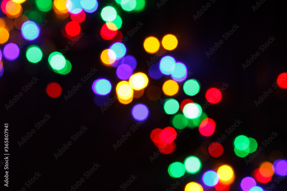 rainbow christmas bokeh lights on a black background