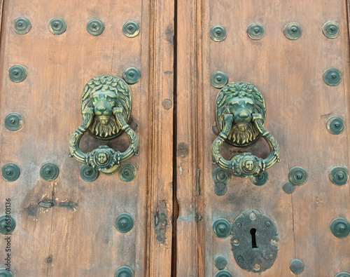 Cordoba, Spain - June 25, 2020: Old fashioned doorbell on wooden door in old town of Priego de Córdoba Andalusia Spain photo