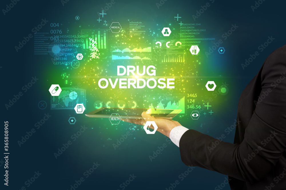 Close-up of a touchscreen with DRUG OVERDOSE inscription, medical concept