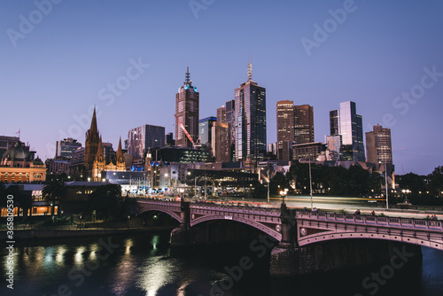 City skyline at night with cars and trams © David