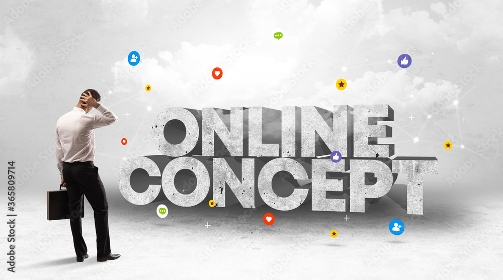 Young businessman standing in front of ONLINE CONCEPT inscription, social media concept Young businessman standing in front of ONLINE CONCEPT inscription, social media concept