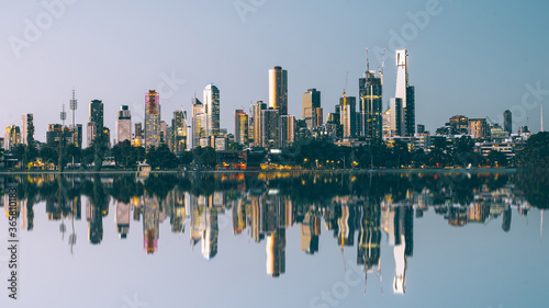 City skyline reflected across water 