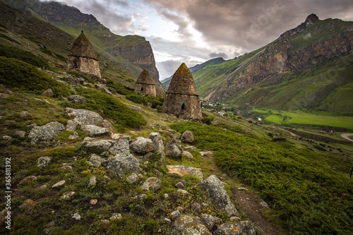 City of the dead, an ancient necropolis located in a picturesque green Caucasus mountain. Cloudy weather. Kabardino-Balkaria, Russia.