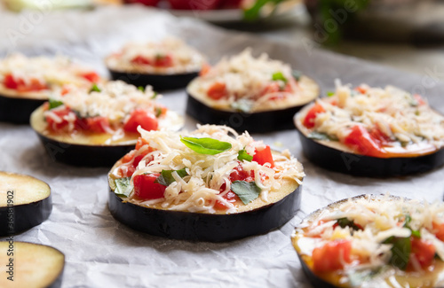 cooking eggplant with tomatoes, basil, pepper and parmesan