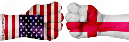 Fototapeta Naklejka Na Ścianę i Meble -  Two hands are clenched into fists and are located opposite each other. Hands painted in the colors of the flags of the countries. England vs USA