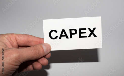 Message on the card CAPEX, in hands of businessman.