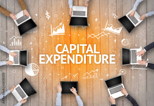 Group of Busy People Working in an Office with CAPITAL EXPENDITURE inscription, succesfull business concept