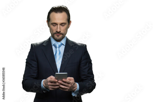 Handsome businessman checking the phone. Portrait of serious businessman isolated on white background.