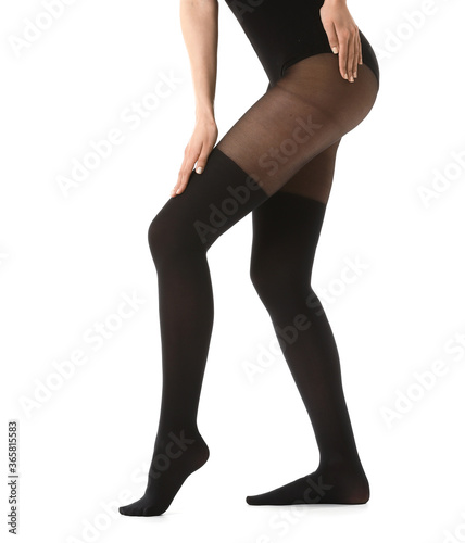 Beautiful young woman in tights on white background