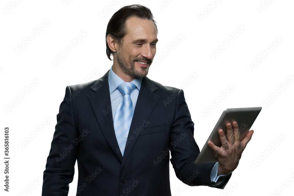 Smiling middle-aged male using digital tablet. Portrait of attractive formal-dressed businessman isolated on white background. Smiling middle-aged male using digital tablet. Portrait of attractive formal-dressed businessman isolated on white background.