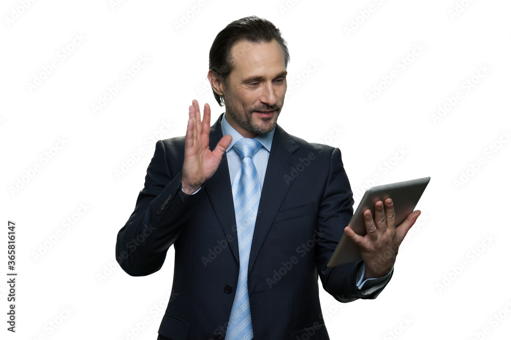 Portrait of confident formal-dressed man usung a tablet. Businessman looking at the tablet isolated on white background. Portrait of confident formal-dressed man usung a tablet. Businessman looking at the tablet isolated on white background.