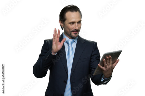 Portrait of confident formal-dressed man usung a tablet. Businessman looking at the tablet isolated on white background. photo