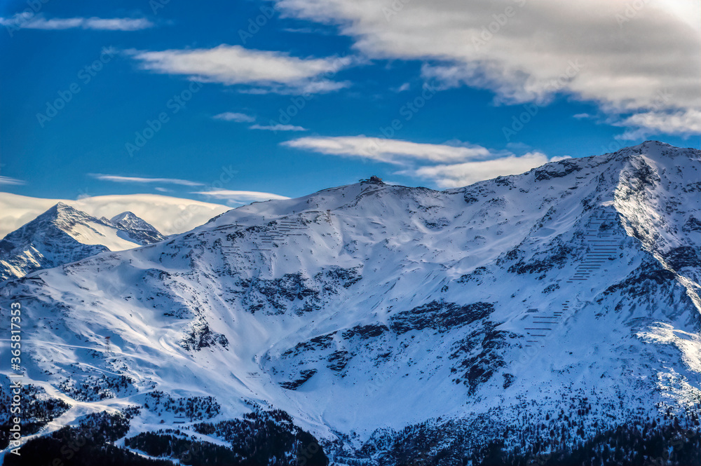 Aerial view over Dolomites mountains peaks covered with snow during winter time.