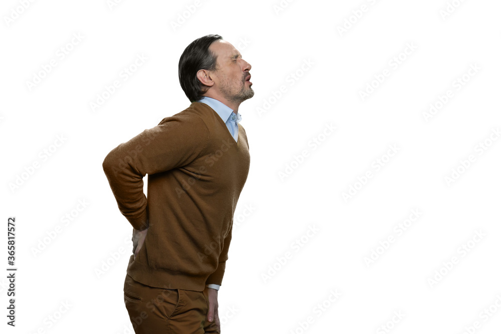 Senior man suffering from the backpain. European man is touching his lower back. Portrait of man with backache isolated on white background. Senior man suffering from the backpain. European man is touching his lower back. Portrait of man with backache isolated on white background.