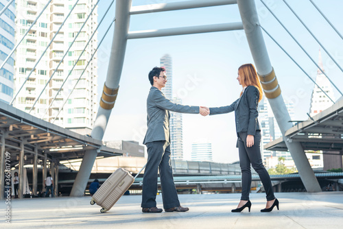 Team Business Partners shaking hands together to Greeting Start up new project. Shakehand Teamwork Partnership outside office modern city background. Businessman handshake together. Business concept