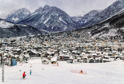 Obraz na płótnie Panoramically view over famous ski town during cloudy winter day in Bormio, Italy. w salonie