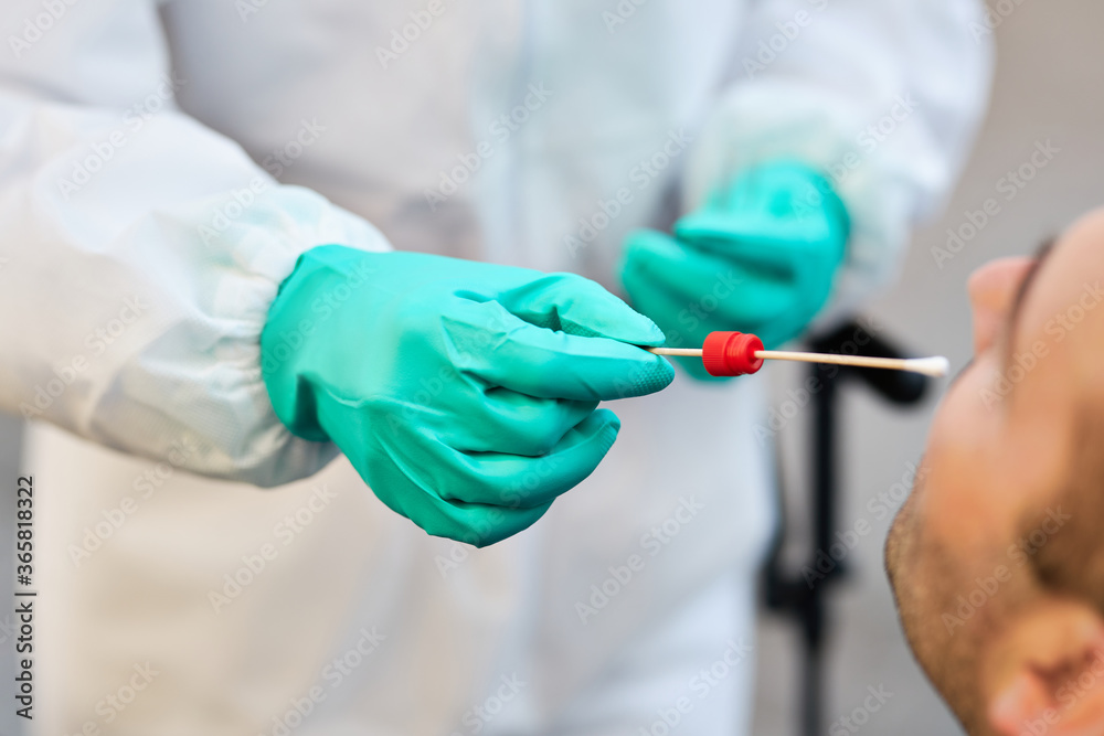Close-up of epidemiologist taking PCR test of a patient during COIVD-19 outbreak. Close-up of epidemiologist taking PCR test of a patient during COIVD-19 outbreak.