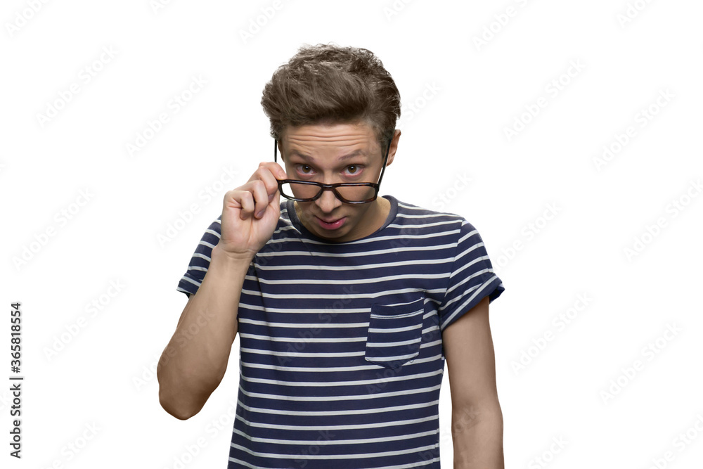 Portrait of bewildered and surprised teen nerdy guy wearing glasses. Isolated on white background. Portrait of bewildered and surprised teen nerdy guy wearing glasses. Isolated on white background.