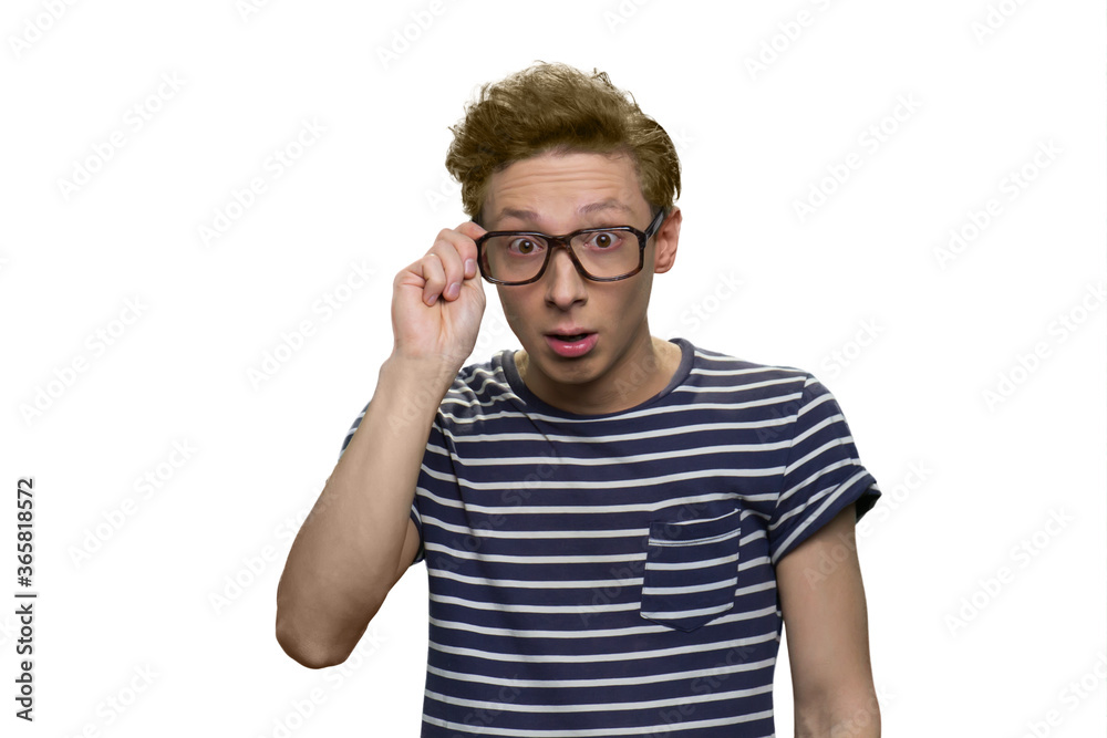 Portrait of surprised teen boy is wearing glasses. Nerdy guy wearing striped t-shirt. Isolated on white background. Portrait of surprised teen boy is wearing glasses. Nerdy guy wearing striped t-shirt. Isolated on white background.