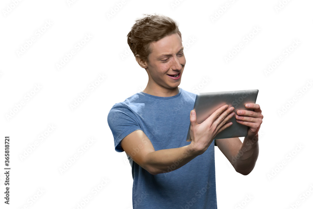 Smiling boy is holding tablet pc. Isolated on white background. Smiling boy is holding tablet pc. Isolated on white background.