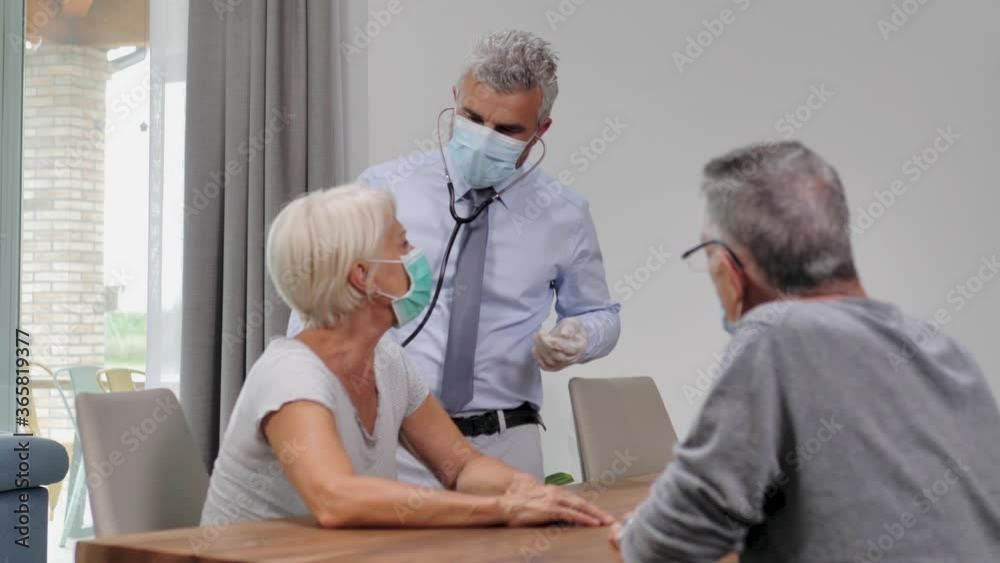 woman with coronavirus covid-19 disease visited at home by doctor that examines her lung capacity with a stethoscope,lock down quarantine woman with coronavirus covid-19 disease visited at home by doctor that examines her lung capacity with a stethoscope,lock down quarantine