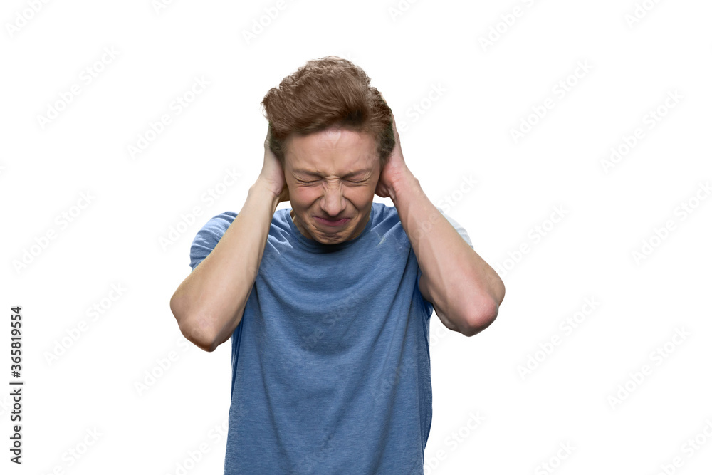 Teenager boy with closed eyes is suffering from terrible head pain. Isolated on white background. Teenager boy with closed eyes is suffering from terrible head pain. Isolated on white background.