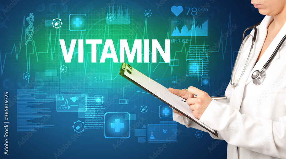 young doctor writing down notes with VITAMIN inscription, healthcare concept young doctor writing down notes with VITAMIN inscription, healthcare concept