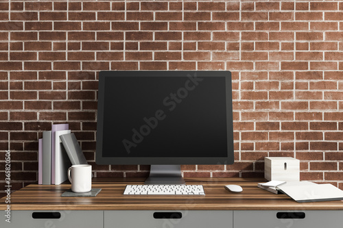 Computer screen in brick room