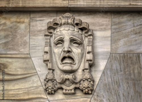 Bas relief decorative mask sculpture on the walls of famous Comedia movie theatre in Barcelona, Spain.