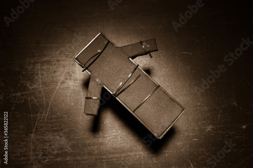 Prisoner handcuffed to death by lethal injection, vial with sodium thiopental and syringe on top of a table, conceptual image