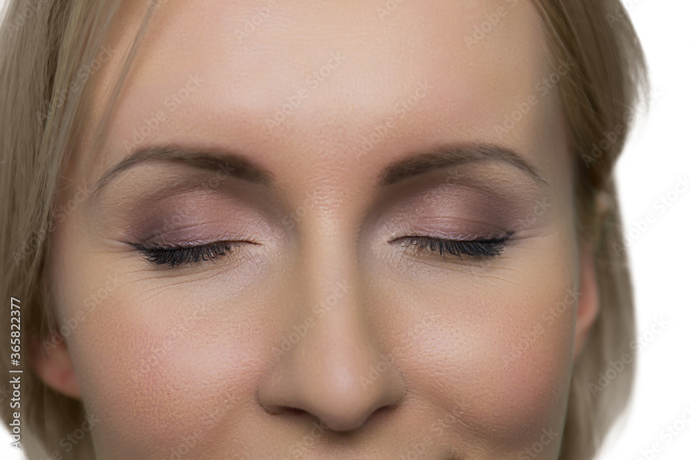 Close-up women face with closed eyes and makeup on white background. Portrait of attractive young woman with natural makeup. Close-up women face with closed eyes and makeup on white background. Portrait of attractive young woman with natural makeup.