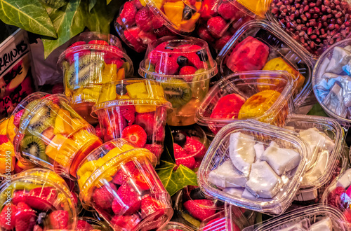 Fresh fruit packed end exposed for sale in plastic containers at La Boqueria market in Barcelona, Spain.