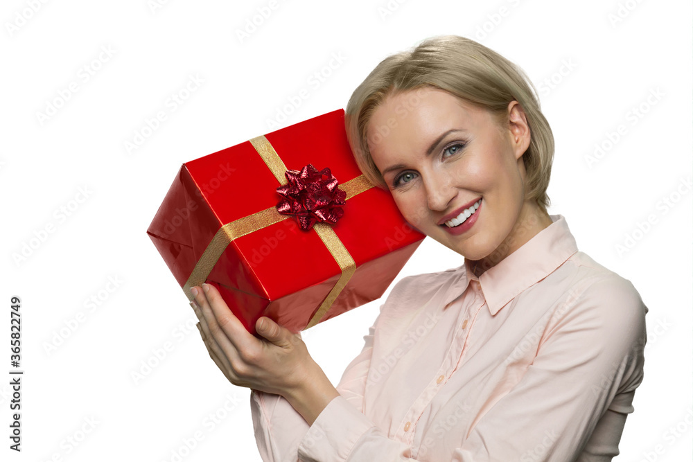 Portrait of smiling joyful woman with celebratory gift box. Giftbox with gold ribbon. Portrait of smiling joyful woman with celebratory gift box. Giftbox with gold ribbon.