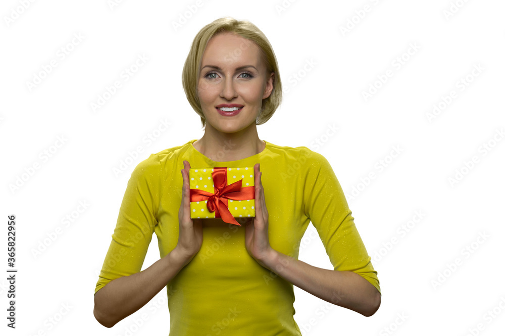 Happy beautiful blonde woman with little yellow gift box isolated on white background. Receiving gifts from. Young attractive woman having a present. Happy beautiful blonde woman with little yellow gift box isolated on white background. Receiving gifts from. Young attractive woman having a present.