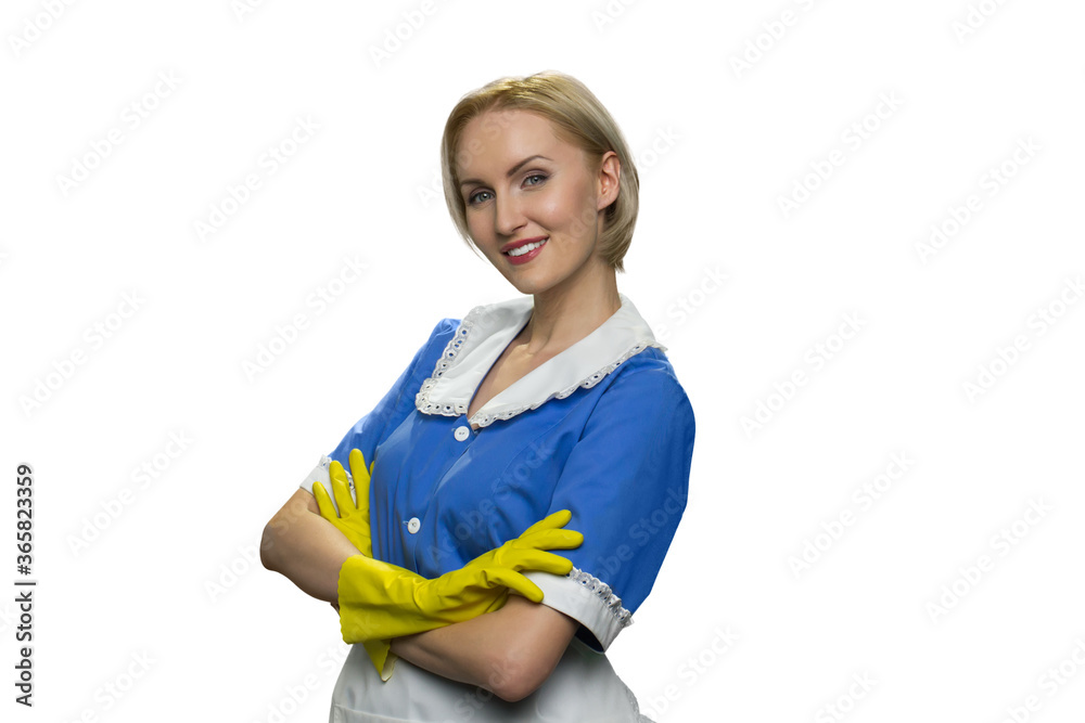 Smiling blonde maid in yellow rubber gloves with crossed arms on white background. Half-turned portrait of cheerful excited lady. Smiling blonde maid in yellow rubber gloves with crossed arms on white background. Half-turned portrait of cheerful excited lady.