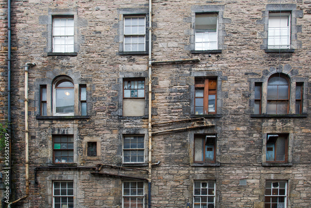A tenement is a multi-occupancy building of any sort. The term usually  refers to a run-down apartment building or slum - Edinburgh, Scotland.  Stock Photo | Adobe Stock
