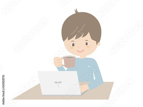 Young man drinking coffee while looking at a laptop.